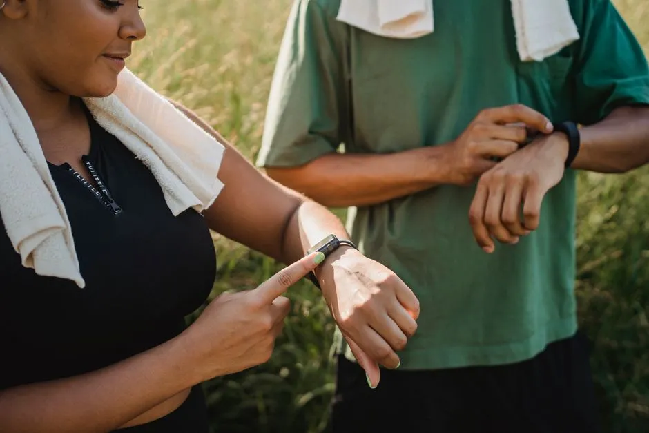 Coureur consultant une montre GPS au poignet sur sentier, écran affichant trace et allure